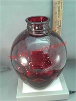Red glass bottle with inverted thumbprint pattern