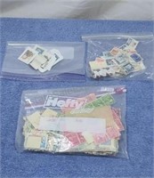 Postage stamps in 3 zip lock bags.