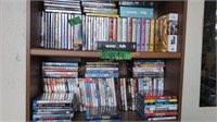 2 shelves DVDs eat prey love, queer as folk
