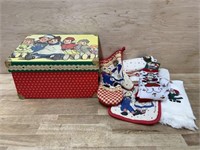 Raggedy Ann storage box with dish towels and pot