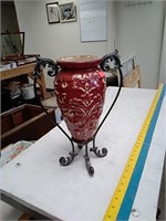 Decorative clay vase with iron stand