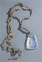 Rene Lalique glass Trefles pendant on silk cord.