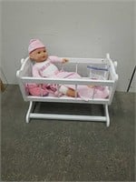 Cute rocking baby crib with baby and accessories