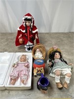 Assortment of dolls, and some coffee cups