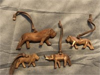 Lot of four carved African animals on strings