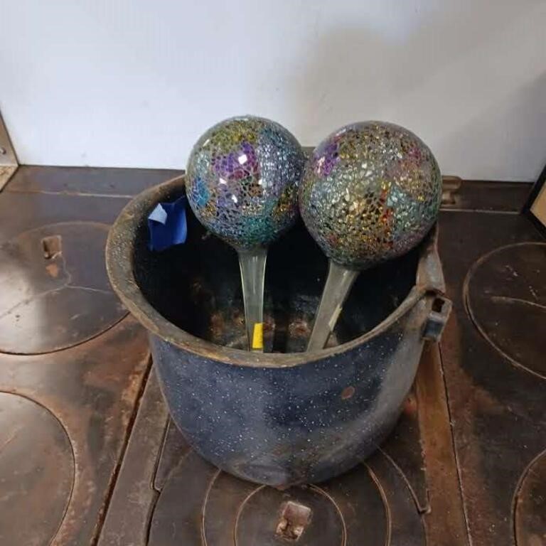 Plant watering globes in enamel pan