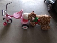 Trike and stuffed animal