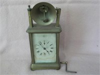 early brass carriage clock with bell on top and