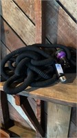 Two black outdoor hoses