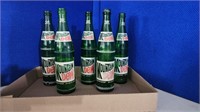 Four vintage pry off top Mountain Dew bottles