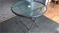 Small round outdoor table with glass top & metal