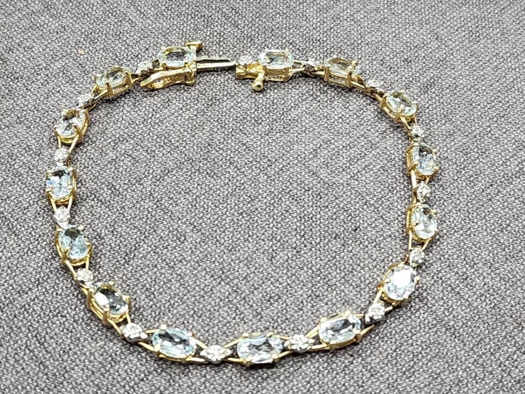 14k gold bracelet with aqua marine stones.  Look