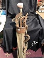 11 antique golf clubs in an original canvas bag,