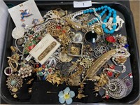Tray of costume jewelry.