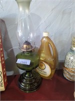 Antique oil lamp with jug of lamp oil