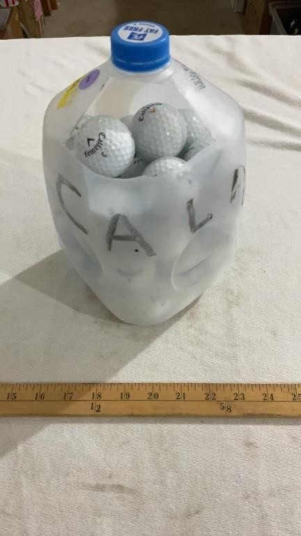 Milk jug full of golf balls