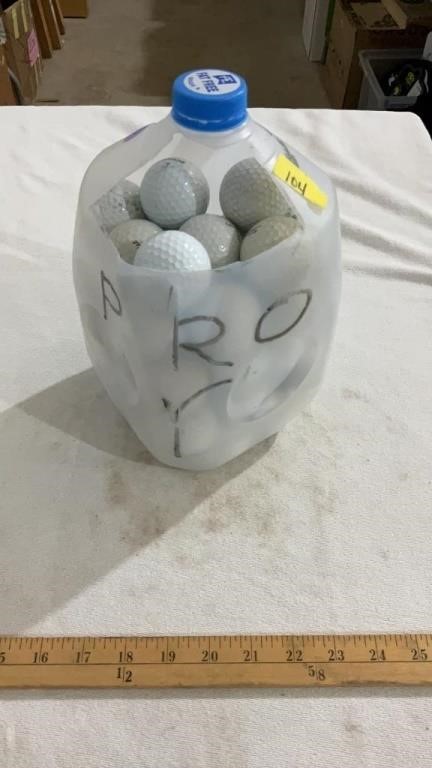 Milk jug full of golf balls