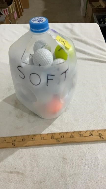 Milk jug full of golf balls