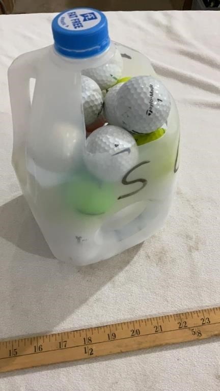 Milk jug full of golf balls
