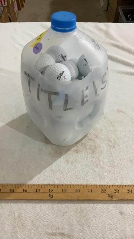 Milk jug full of golf balls