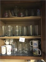 Cabinet full of assorted glasses, some coca cola