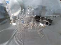 Beakers, glass measuring cups and a doctors drug
