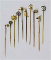 A collection of gold and gemstone stick pins