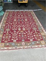 Burgandy an olive patterned area rug,