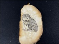 Walrus ivory necklace pendant with a scrimmed pupp