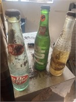 (3) glass pop bottles.