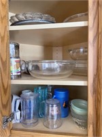 BOWLS AND GLASS COOKWARE IN KITCHEN CABINET