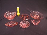 Six pieces of pink glassware and yellow