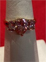 Pink CZ ring with three stones. Gold tone