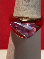Large pink CZ stone in a gold tone setting ring.