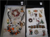 Two containers of holiday jewelry