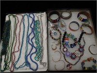 Two containers of jewelry including glass
