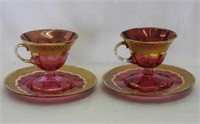 Pair of Moser cranberry decorated cups & saucers