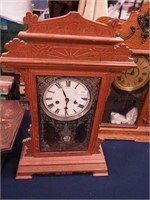 A striking shelf clock with decorative pendulum