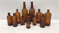 Lot of (12) Amber glass bottles.