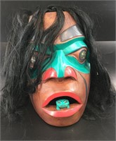 Tlingit mask with simulated hair trim, frog in mou