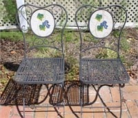 two folding wrought iron chairs