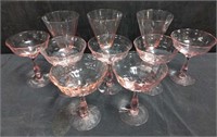 Group of pink Champagne coupes & wine glasses