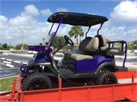Purple four seater lifted golf cart