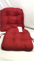 C6). 2 RED CHAIR CUSHIONS, MATCHING PAIR ( one