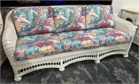 White Wicker Patio Sofa with Floral Cushions