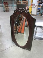 Bevelled mirror in carved frame