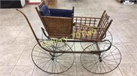 Antique baby buggy-has large metal wheels, wooden
