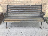 Two-seater park bench made from wood and wrought