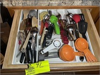 Drawer to right of the stove with misc cookware