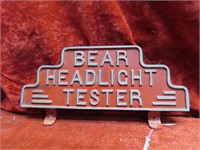 Cast Bear Headlight Tester sign.